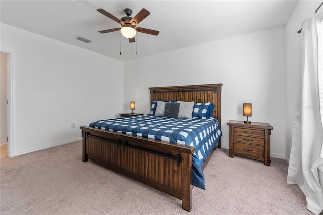 bedroom with light carpet and ceiling fan