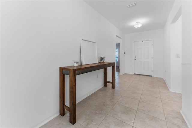 hallway featuring light tile patterned floors