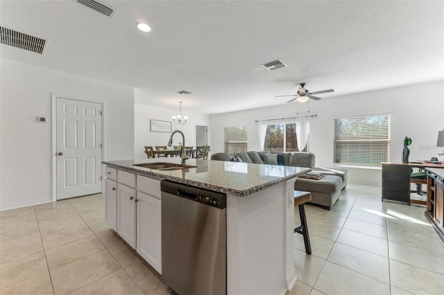 kitchen with ceiling fan with notable chandelier, white cabinetry, dishwasher, sink, and an island with sink