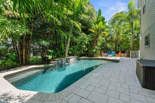 view of pool with a patio and pool water feature