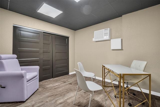 office area with a drop ceiling and hardwood / wood-style flooring