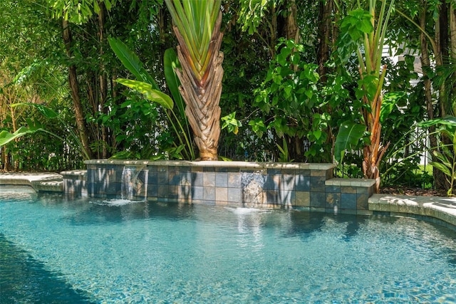 view of pool with pool water feature