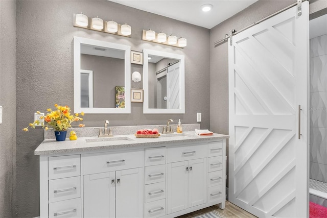 bathroom with vanity, wood-type flooring, and walk in shower