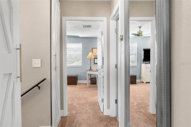 hallway with light colored carpet