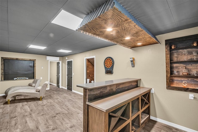 bar featuring hardwood / wood-style flooring and a paneled ceiling