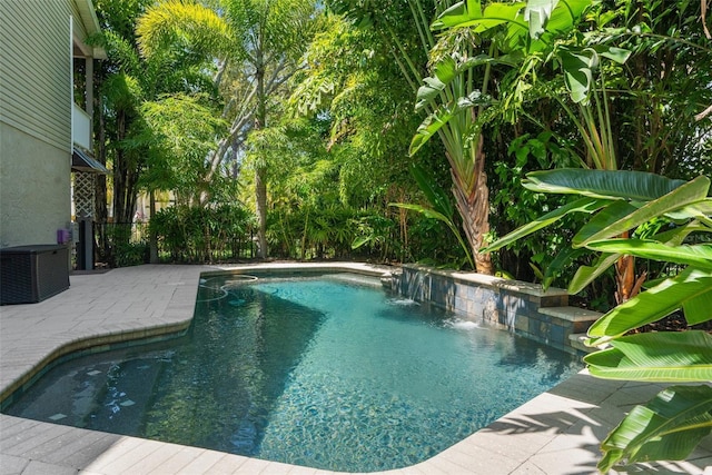 view of swimming pool with a patio, pool water feature, and central air condition unit