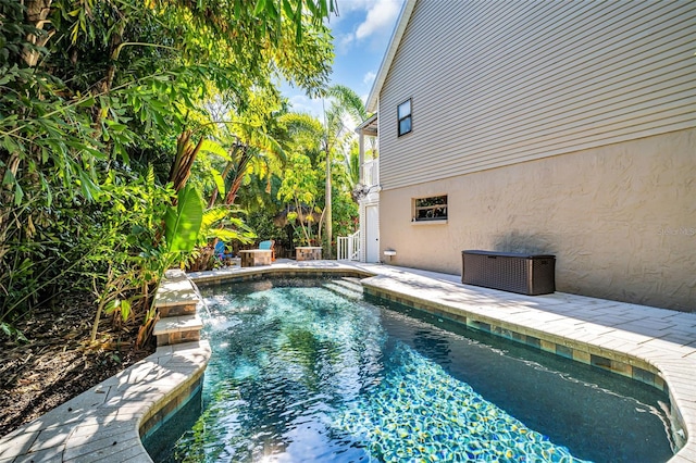 view of swimming pool with pool water feature