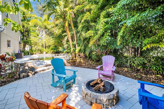 view of patio / terrace featuring an outdoor fire pit