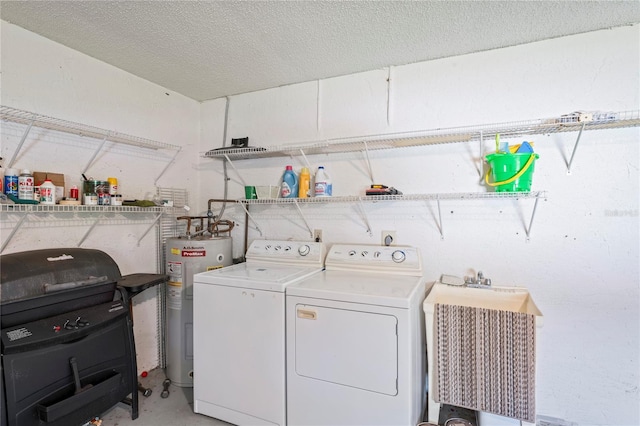 laundry area featuring sink, washer and clothes dryer, electric water heater, and a textured ceiling