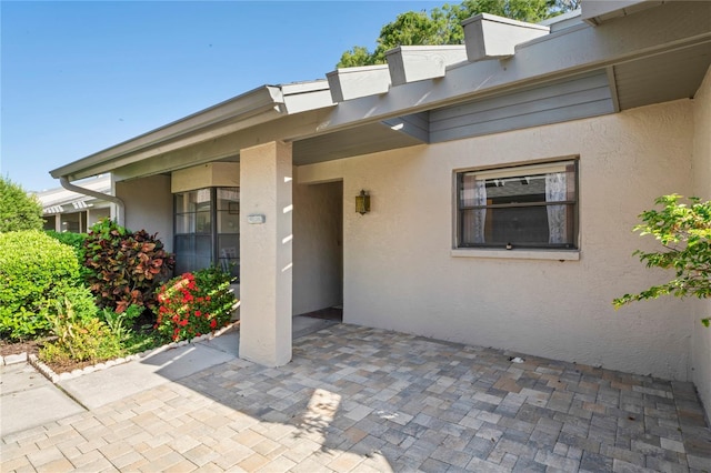 doorway to property with a patio area