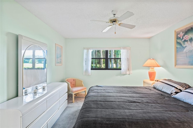 bedroom with multiple windows, a textured ceiling, and carpet flooring