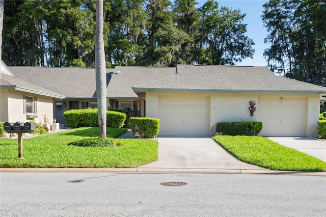 ranch-style house with a garage and a front yard