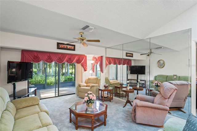 carpeted living room featuring a textured ceiling, ceiling fan, and lofted ceiling