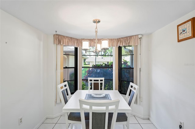 tiled dining area featuring a chandelier