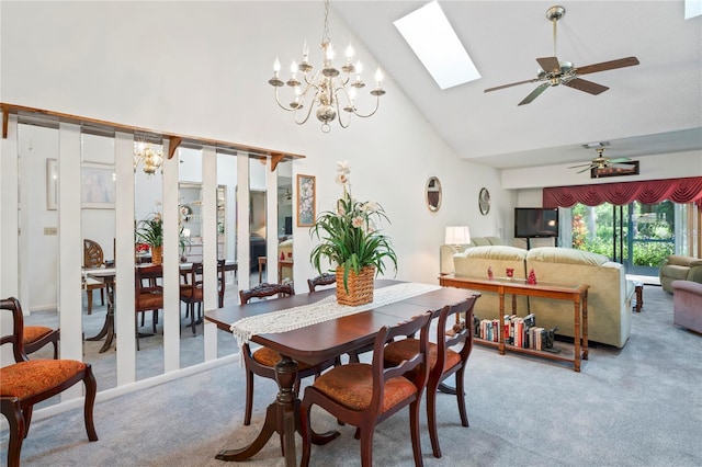 carpeted dining area with a skylight, ceiling fan with notable chandelier, and high vaulted ceiling