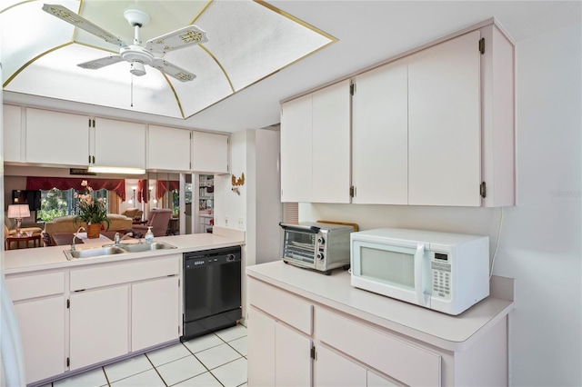 kitchen with black dishwasher, sink, and white cabinets