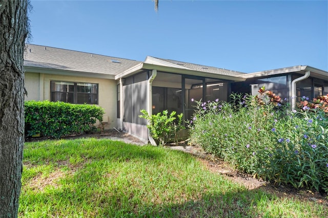 back of property featuring a sunroom