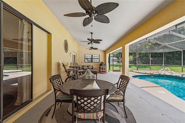 view of patio featuring glass enclosure and ceiling fan