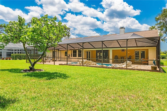 back of house with a patio area, a lanai, and a yard