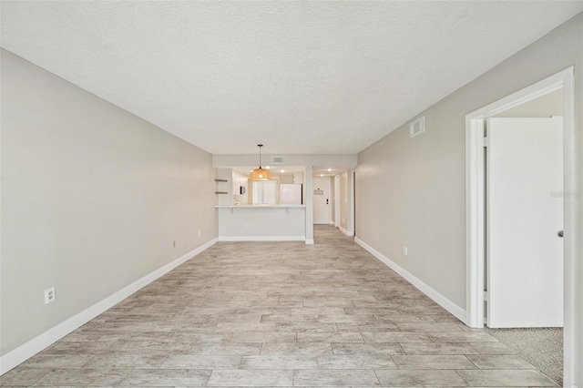 unfurnished living room with a textured ceiling