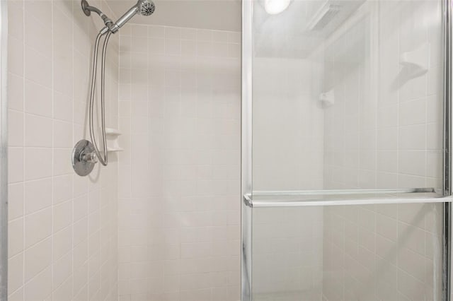 bathroom with a shower with shower door