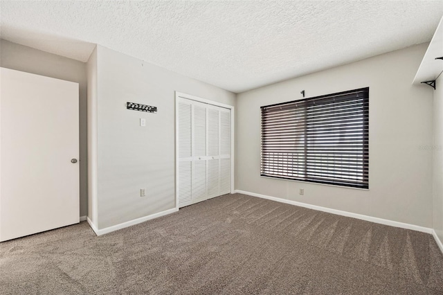 unfurnished bedroom with a closet, a textured ceiling, and carpet flooring