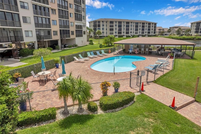 view of swimming pool with a lawn and a patio