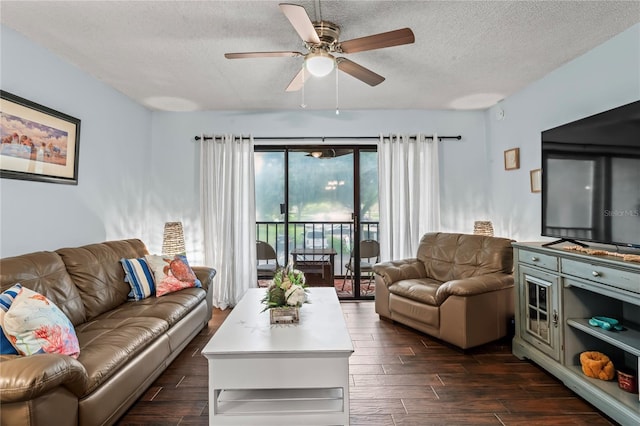 living room with ceiling fan and a textured ceiling