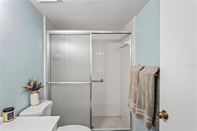 bathroom featuring toilet and walk in shower