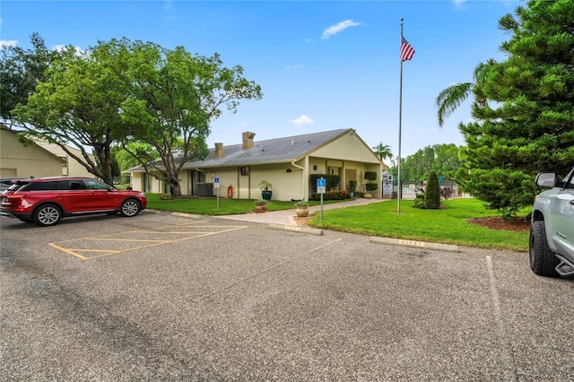 single story home with a front yard and central AC