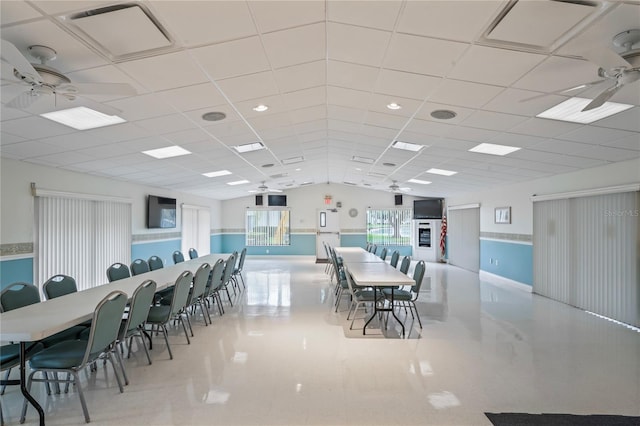 dining area with ceiling fan and a drop ceiling