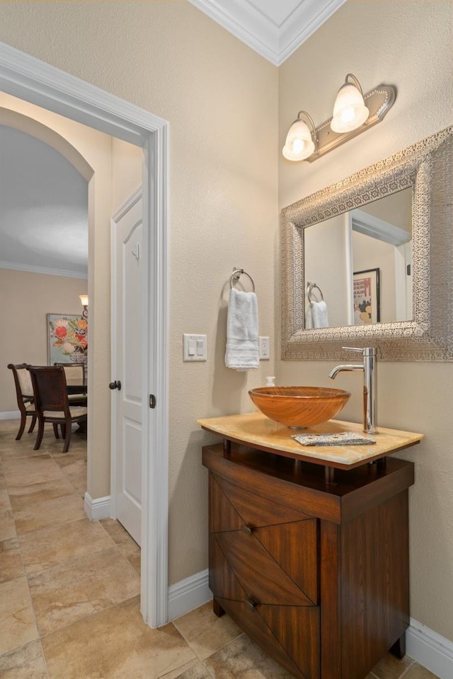 bathroom with vanity and ornamental molding