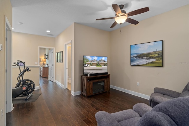 living room with dark hardwood / wood-style floors and ceiling fan