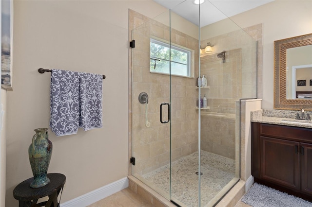 bathroom featuring vanity and a shower with shower door