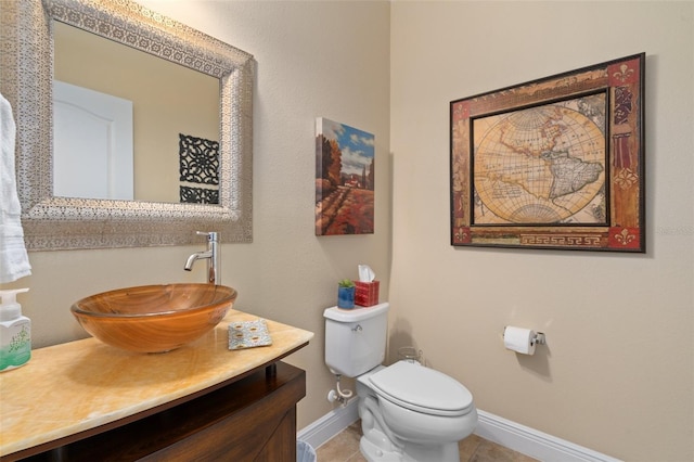 bathroom with tile patterned flooring, vanity, and toilet