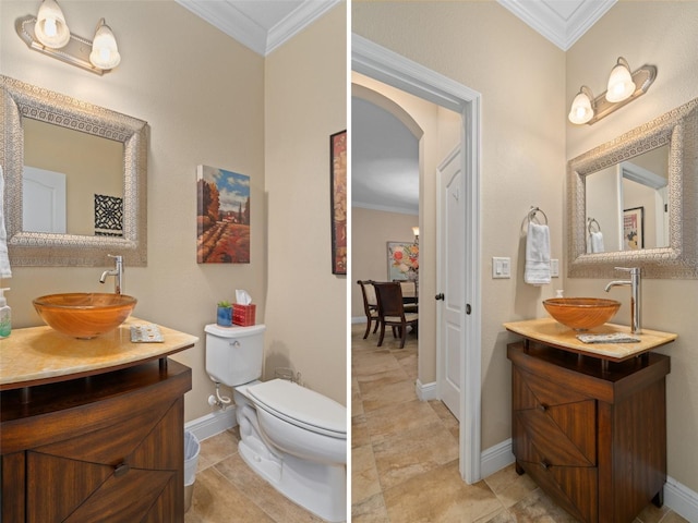 bathroom with crown molding, vanity, and toilet