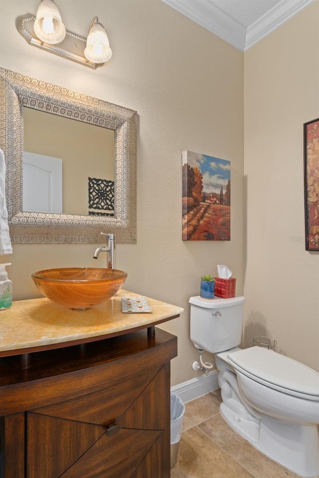 bathroom with tile patterned floors, vanity, toilet, and ornamental molding