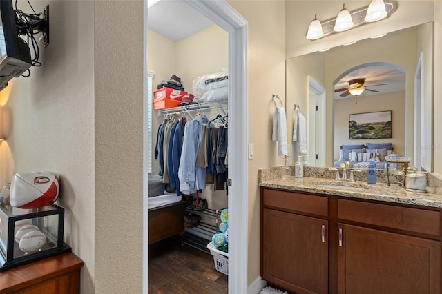 bathroom featuring hardwood / wood-style floors, vanity, and ceiling fan