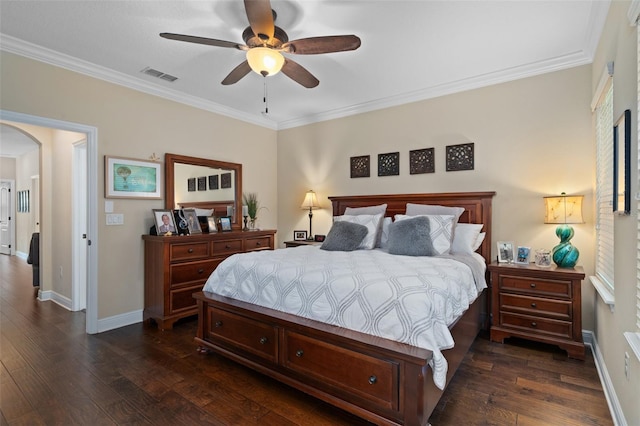 bedroom featuring ceiling fan, crown molding, and dark wood-type flooring