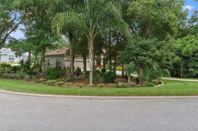 view of front of property featuring a garage and a front yard