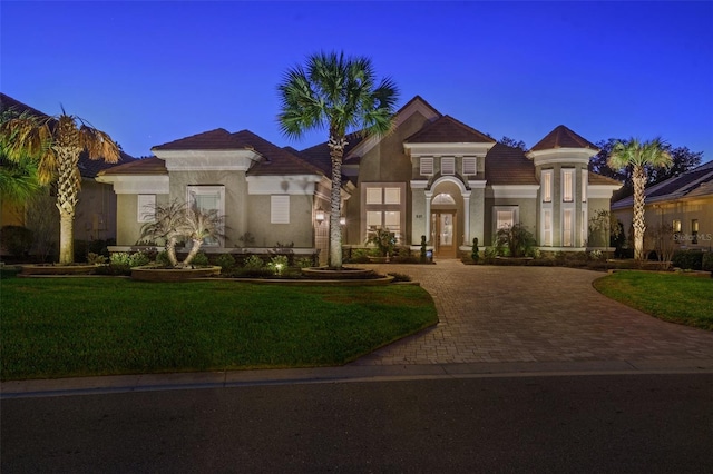 mediterranean / spanish house with central air condition unit and a front yard