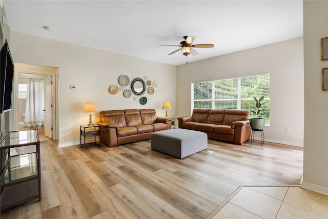 living room featuring light hardwood / wood-style flooring and ceiling fan