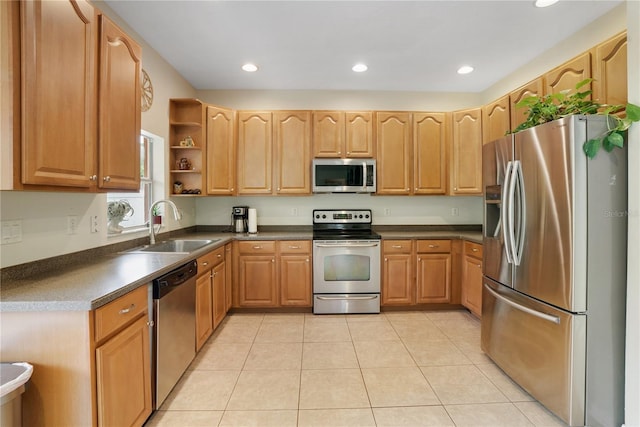 kitchen with sink, light tile patterned floors, and stainless steel appliances