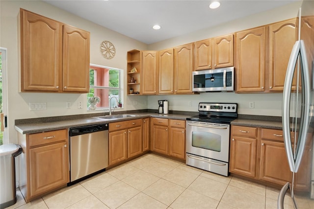 kitchen with sink, light tile patterned floors, and stainless steel appliances