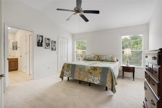 bedroom featuring ensuite bath, light colored carpet, ceiling fan, a closet, and lofted ceiling