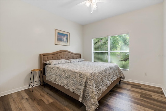 bedroom with ceiling fan and dark hardwood / wood-style flooring