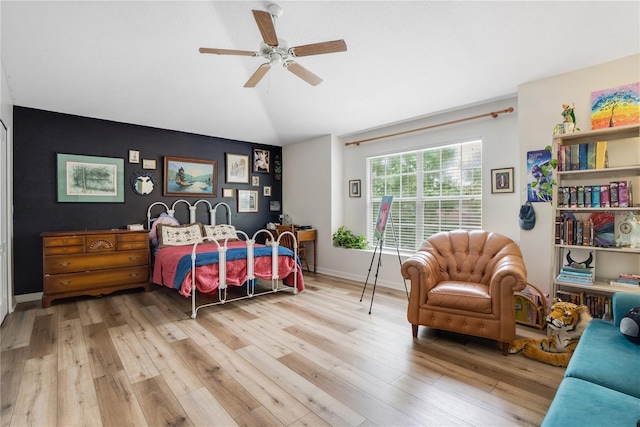 bedroom featuring ceiling fan, lofted ceiling, and light hardwood / wood-style flooring