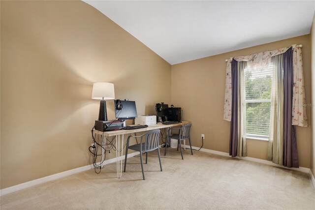 office space with light colored carpet and vaulted ceiling