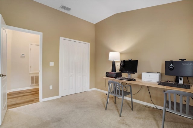 office area featuring light colored carpet and lofted ceiling