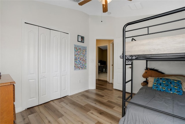 bedroom with ceiling fan, light wood-type flooring, and a closet